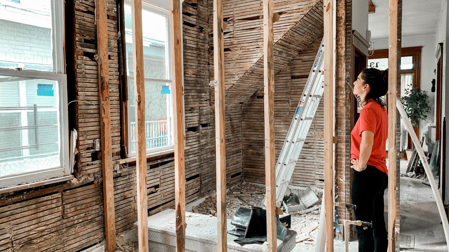 House interior completely gutted down to structural wooden beams for major drywall and plumbing renovations.